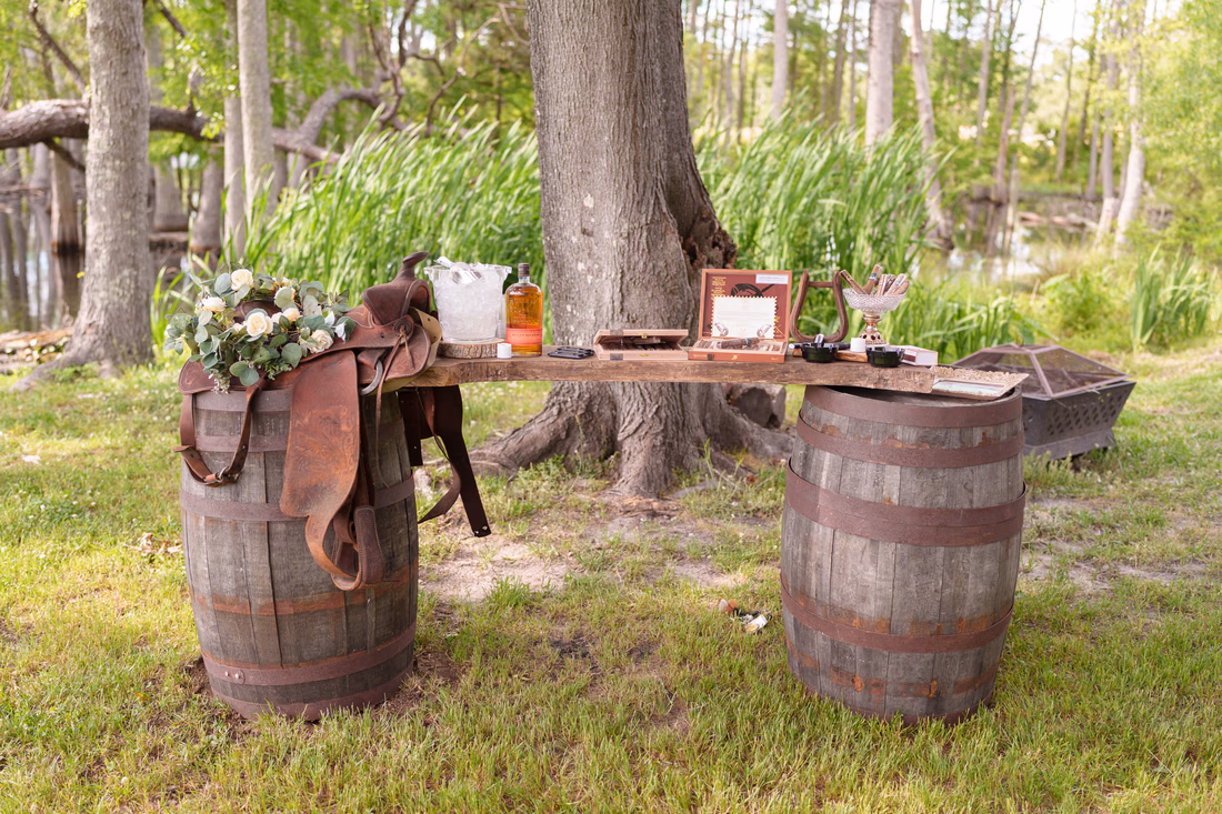 Cigar bar on a wooden plank over whiskey barrels under the trees at Wildhorse at Parker Farms
