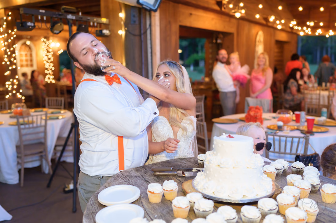 Groom with a face full of cake during the cake cutting at Wildhorse at Parker Farms