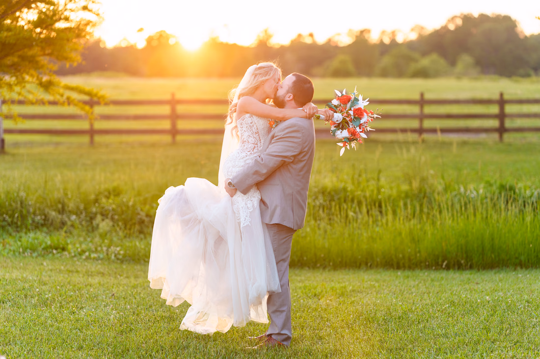 Groom lifting bride into the air - Wildhorse at Parker Farms