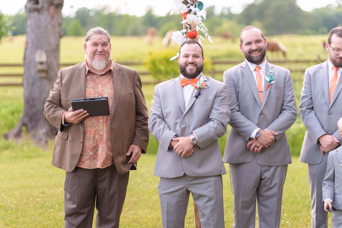 Officiant, groom and groomsmen smiling as they wait for the bride at Wildhorse at Parker Farms