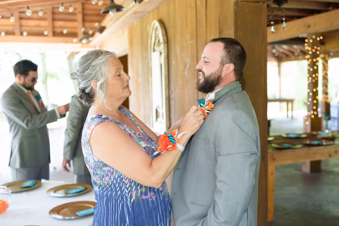 Mom helping groom with boutonniere - Wildhorse at Parker Farms