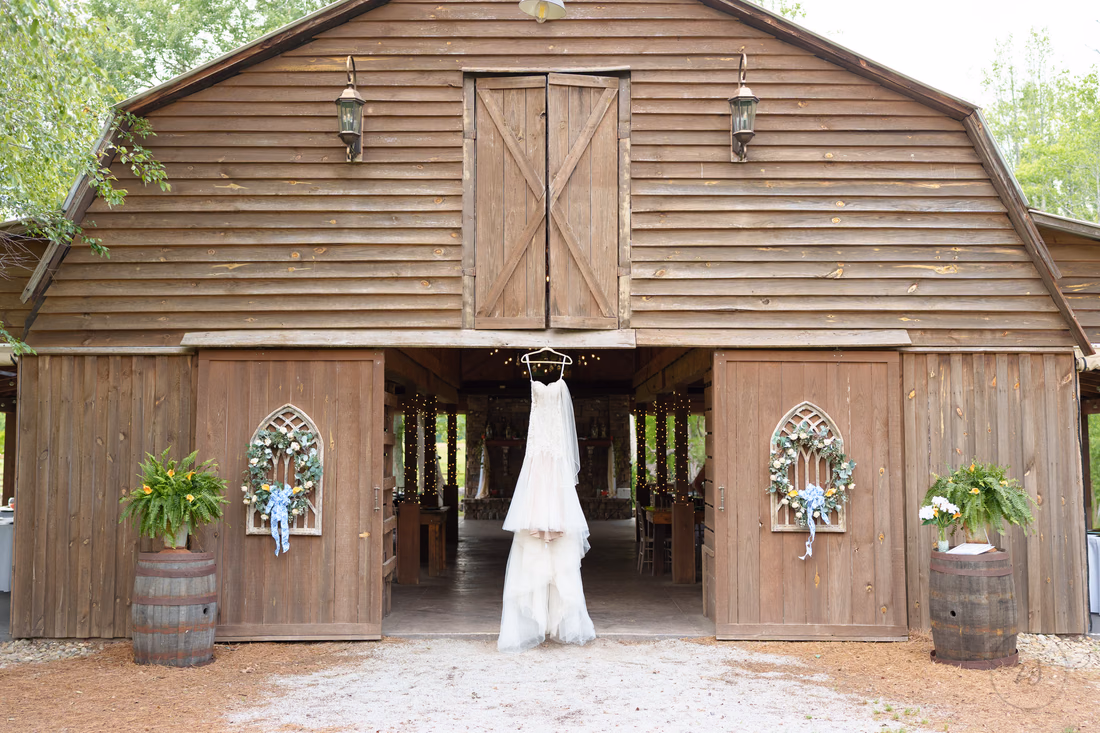 Wedding dress hanging in the barn doors - Wildhorse at Parker Farms