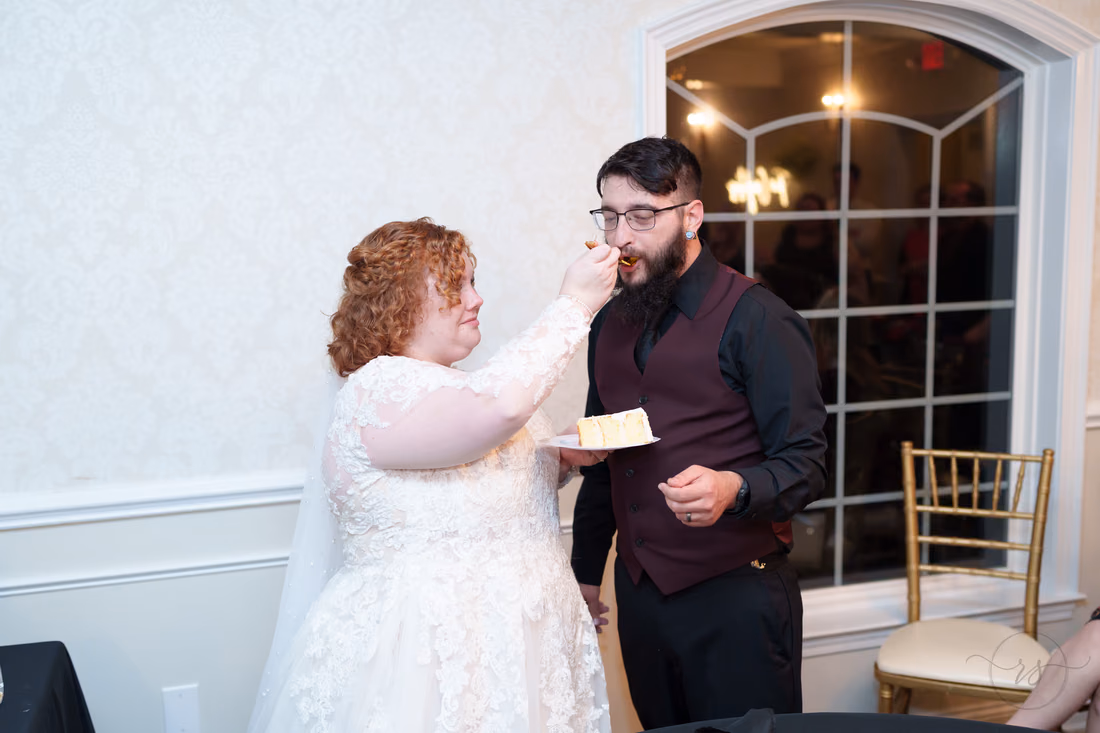 Bride feeds the groom a bite of wedding cake at The Cypress Inn in Conway