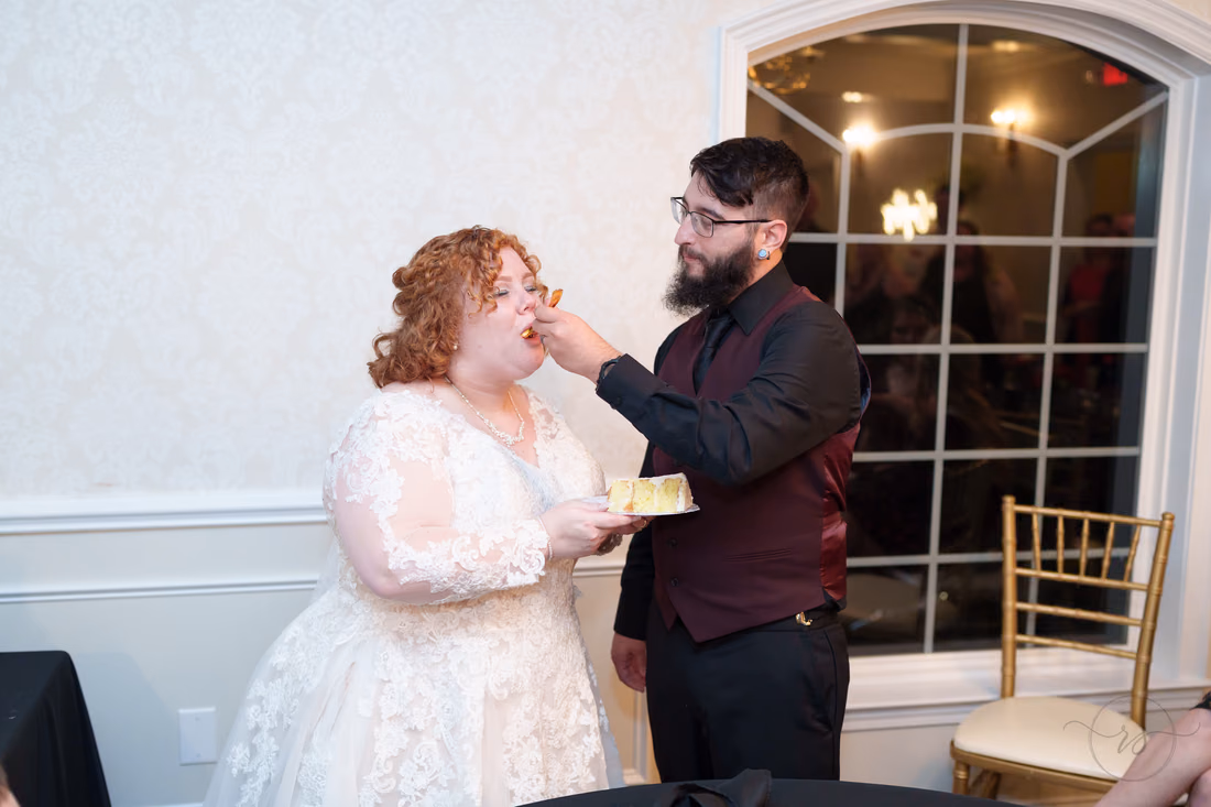 Groom feeds the bride a bite of wedding cake at The Cypress Inn in Conway