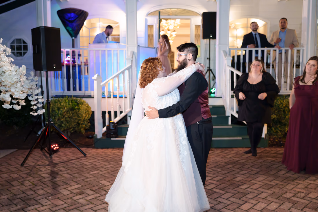 Couple dancing on the patio at night as friends watch at The Cypress Inn in Conway