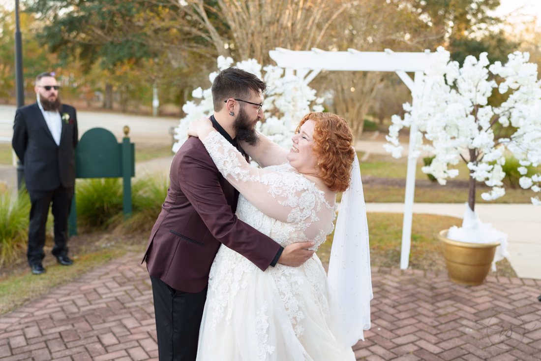 Bride and groom embrace during their first dance on the patio at The Cypress Inn in Conway