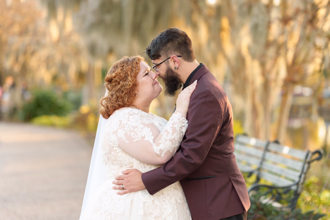 Couple touching noses on the moss-covered path on the Conway Riverwalk