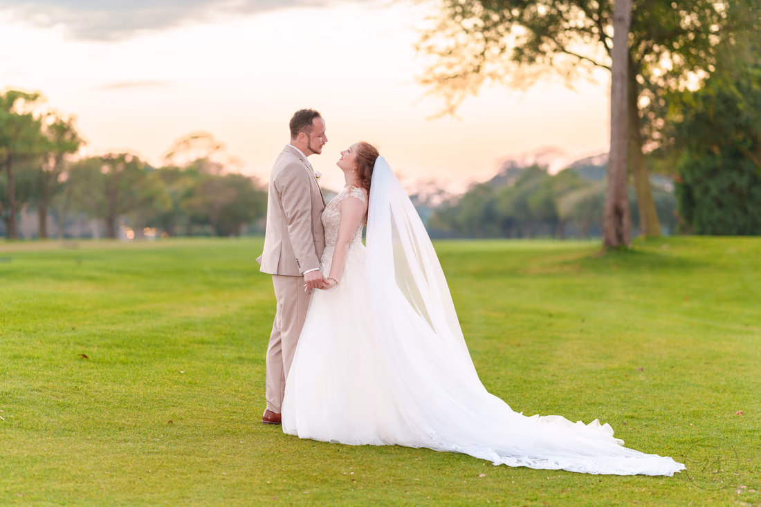 The bride and groom face each other on the golf course after sunset at Pine Lakes Country Club