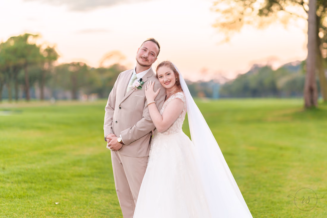 Close portrait of the bride and groom on the golf course at dusk at Pine Lakes Country Club