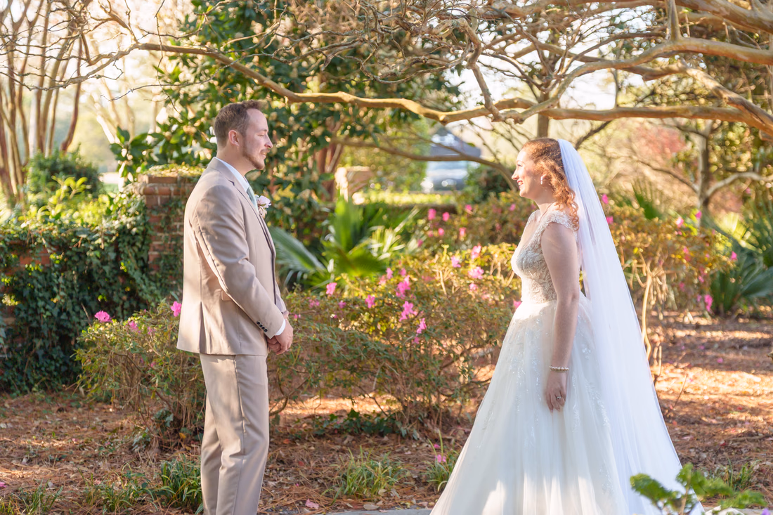 The groom turns to see the bride for the first time in the garden at Pine Lakes Country Club