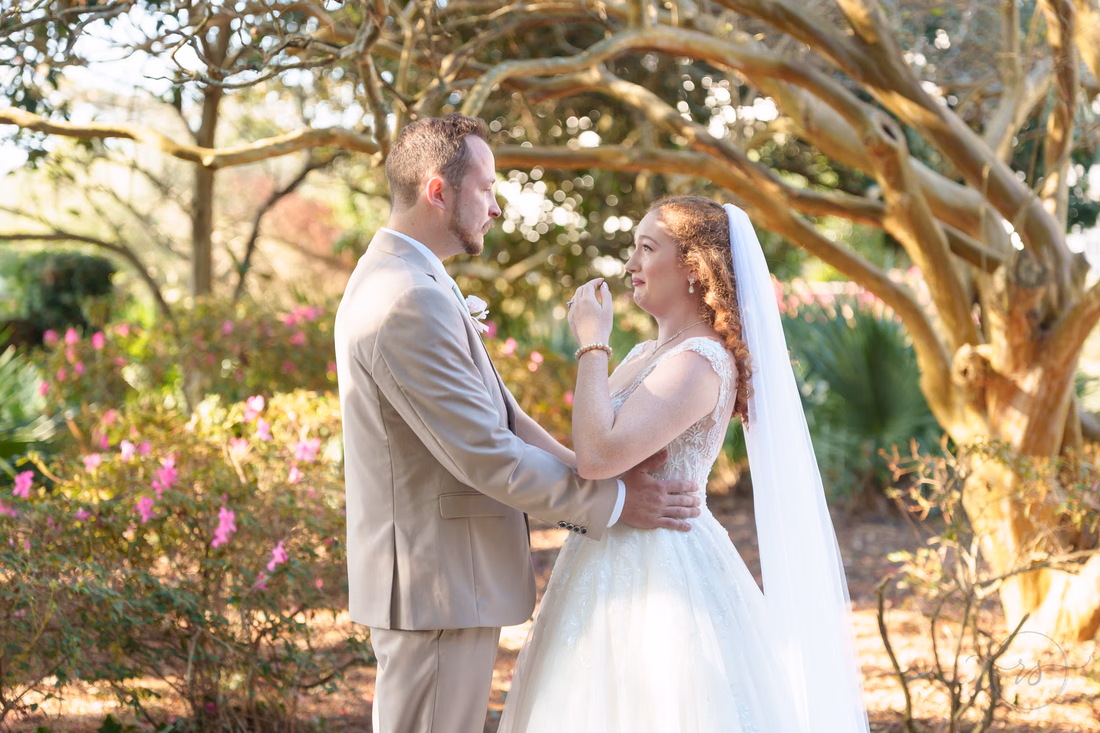 The couple embraces during their first look in the garden at Pine Lakes Country Club