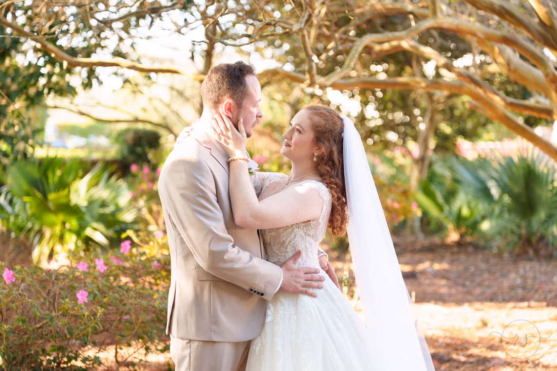 The bride and groom hold each other close in the garden at Pine Lakes Country Club
