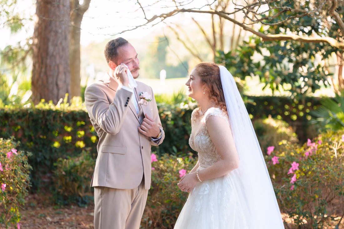 The groom wipes a tear as the bride laughs during the first look at Pine Lakes Country Club