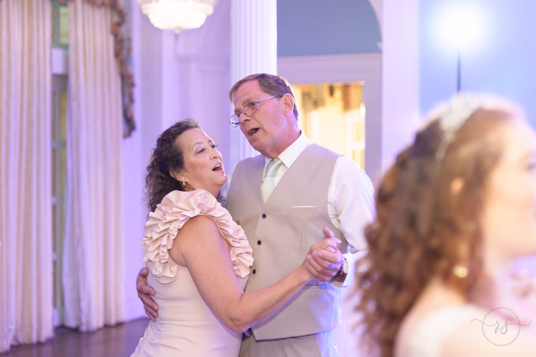An older couple dances cheek to cheek during the reception at Pine Lakes Country Club