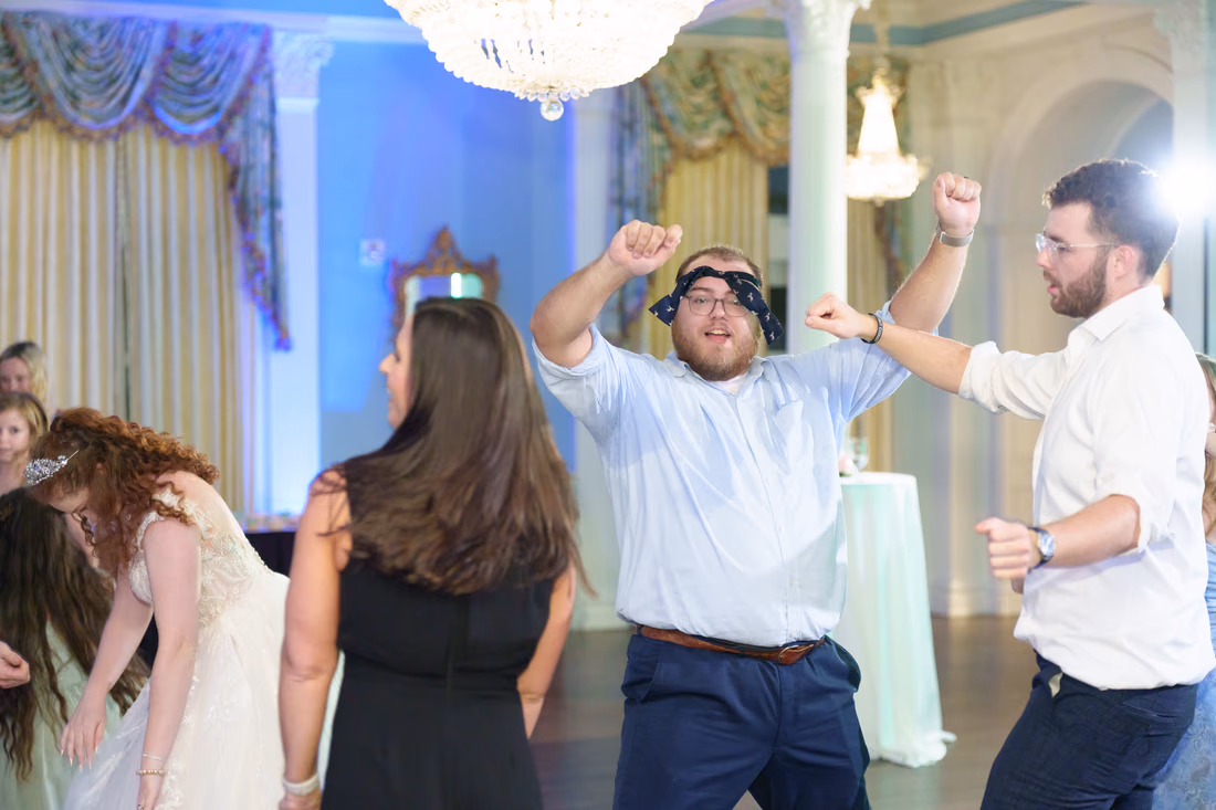 Guests dance with their fists in the air at Pine Lakes Country Club
