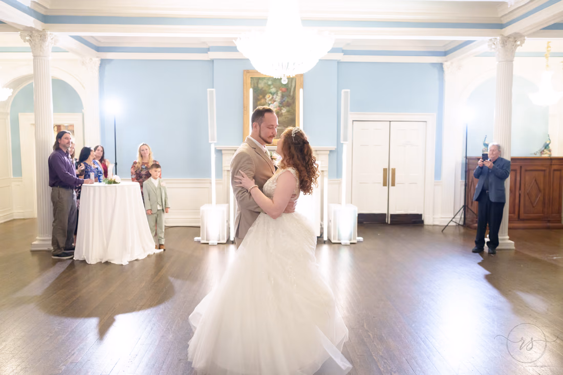 The bride and groom begin their first dance in the ballroom at Pine Lakes Country Club
