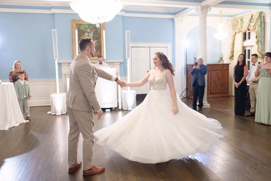 The bride's gown swirls as the groom twirls her on the dance floor at Pine Lakes Country Club