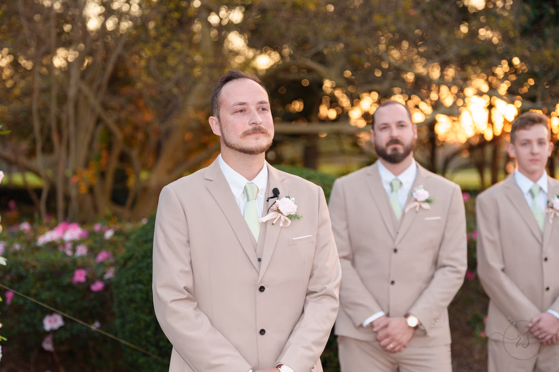 The groom watches the bride come down the aisle at Pine Lakes Country Club