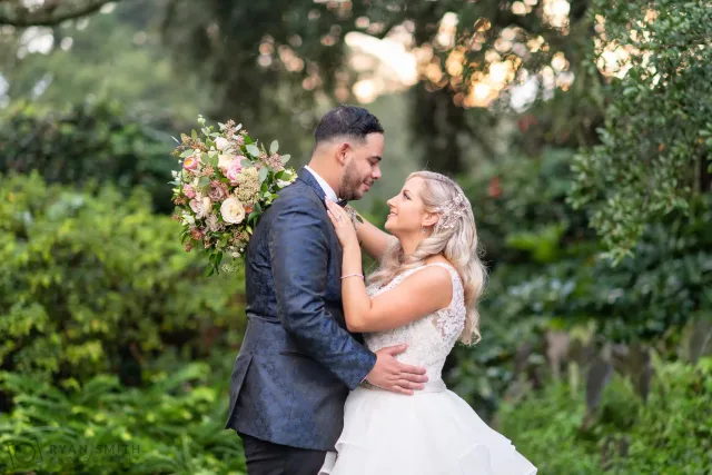 Bride and groom looking into each other's eyes in the garden at Litchfield Country Club