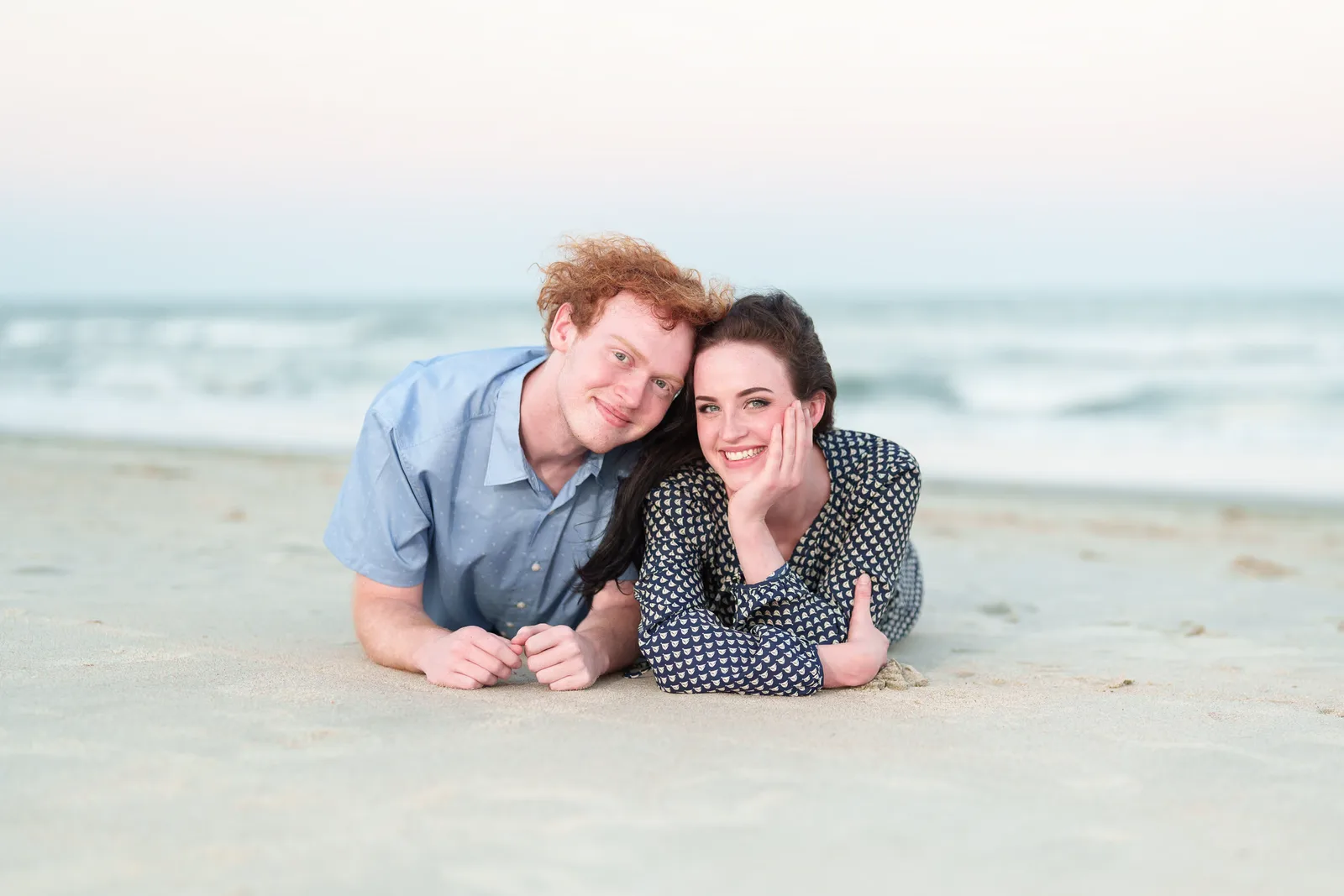 Sister with her little brother laying by the ocean - Huntington Beach State Park
