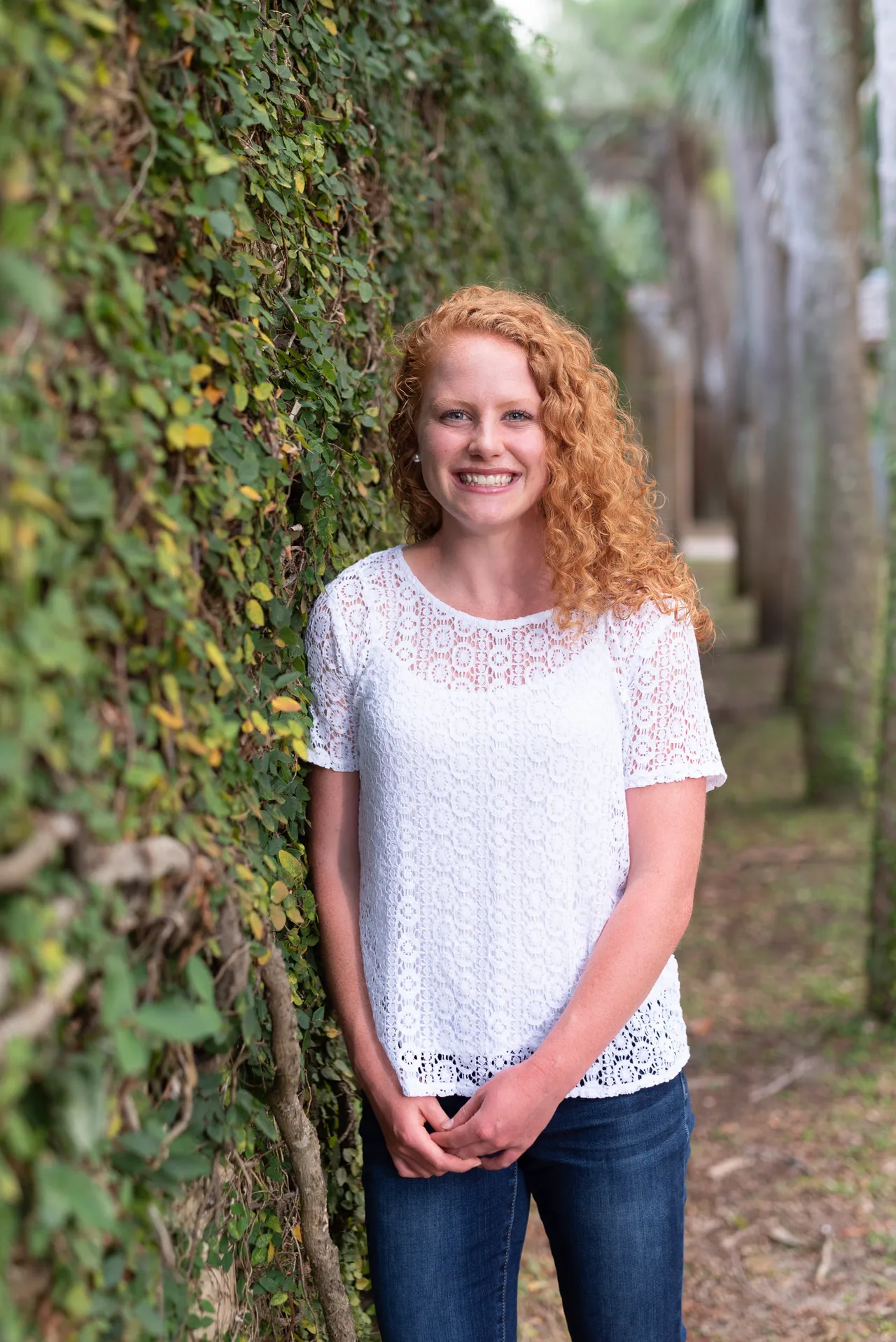 Girl smiling by the castle wall - Huntington Beach State Park