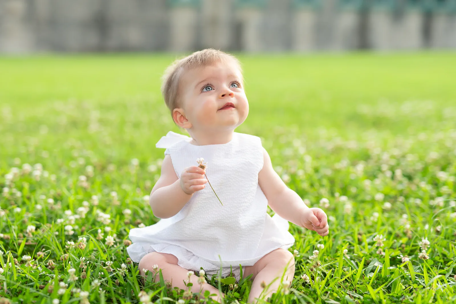 Very cute baby sitting in the grass - Atalaya Castle