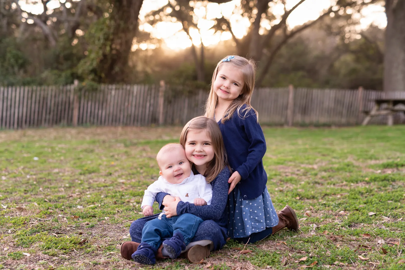 Two sisters holding baby brother by the trees - Myrtle Beach State Park