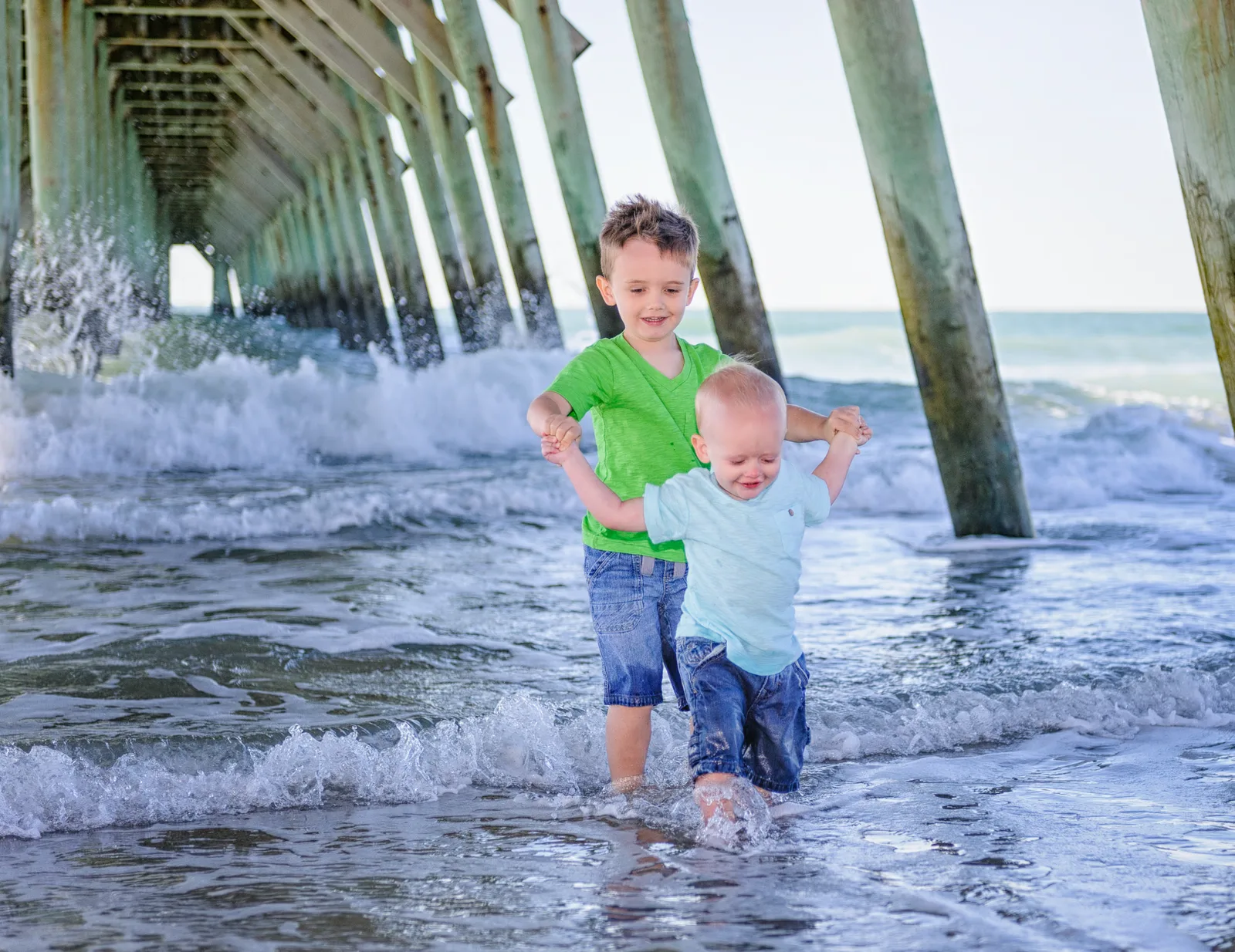 Helping his little brother make it out the ocean - Myrtle Beach State Park Pier