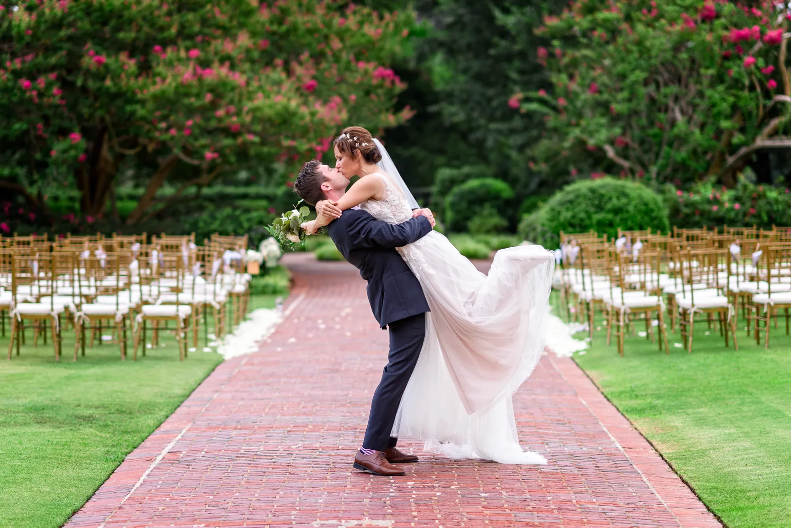 Groom lifting bride in the air for a kiss - Pine Lakes Country Club
