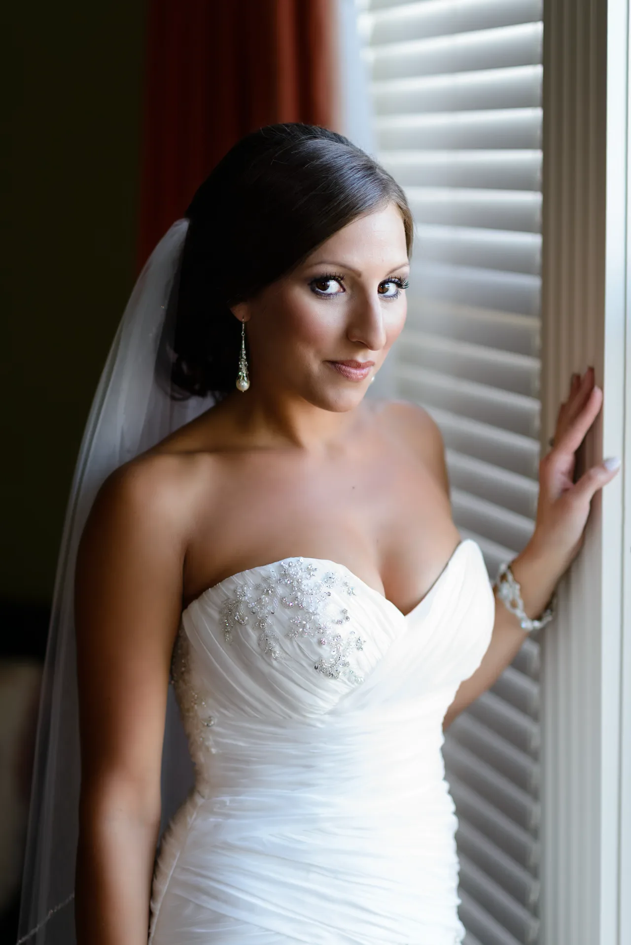 Bride standing on windowlight - Beach house in Myrtle Beach