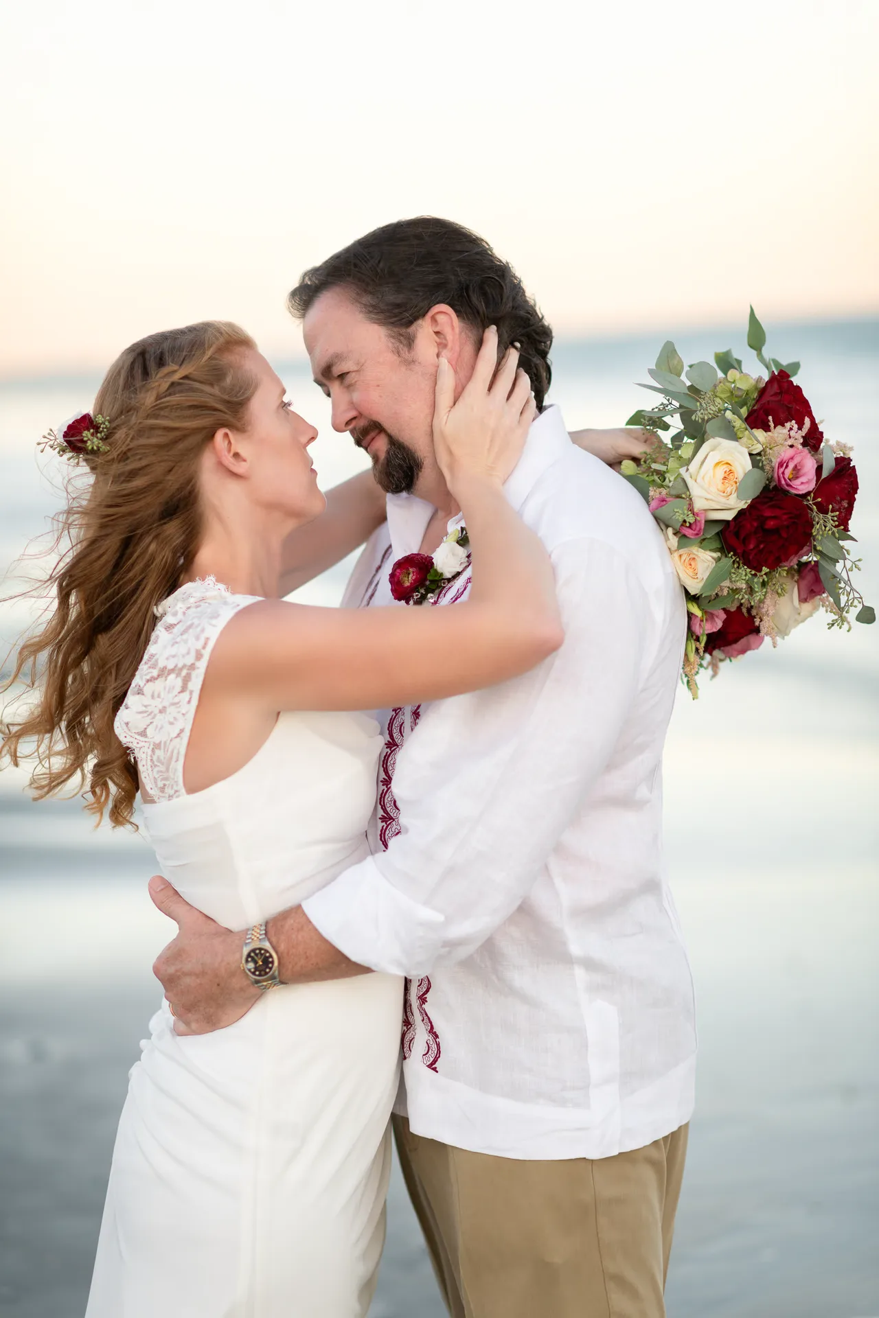Pulling groom in for a kiss in front of the ocean - Grande Dunes Ocean Club - Myrtle Beach
