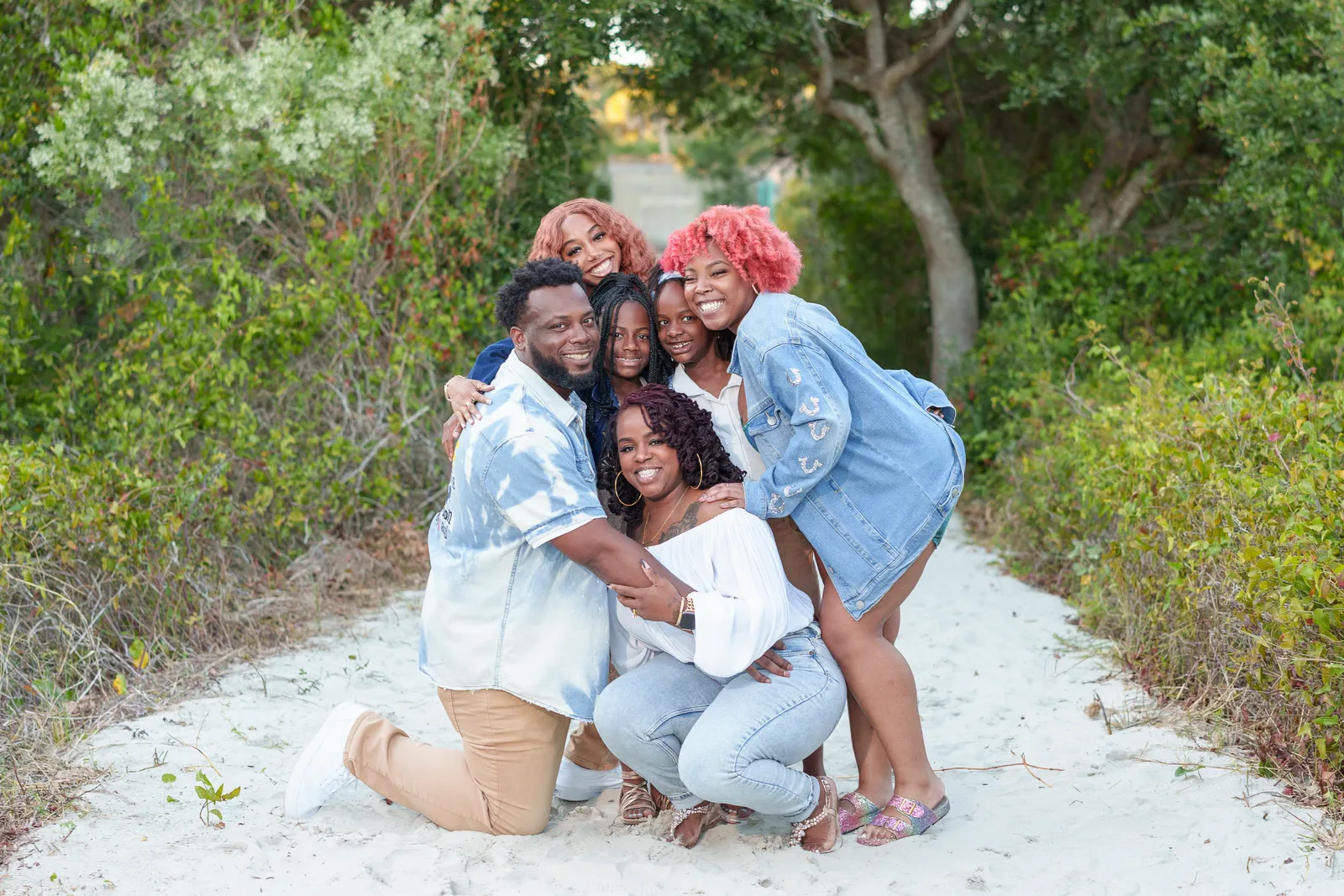 Cute family giving a big hug on the beach path - Huntington Beach State Park