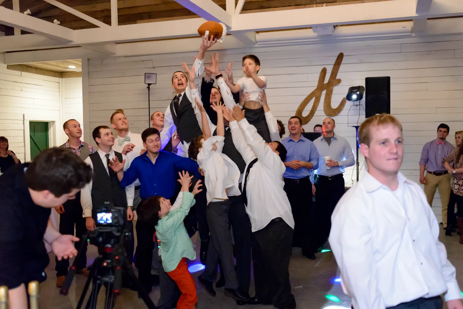 Single guys fighting to catch a football with the garter - Wildberry Farms