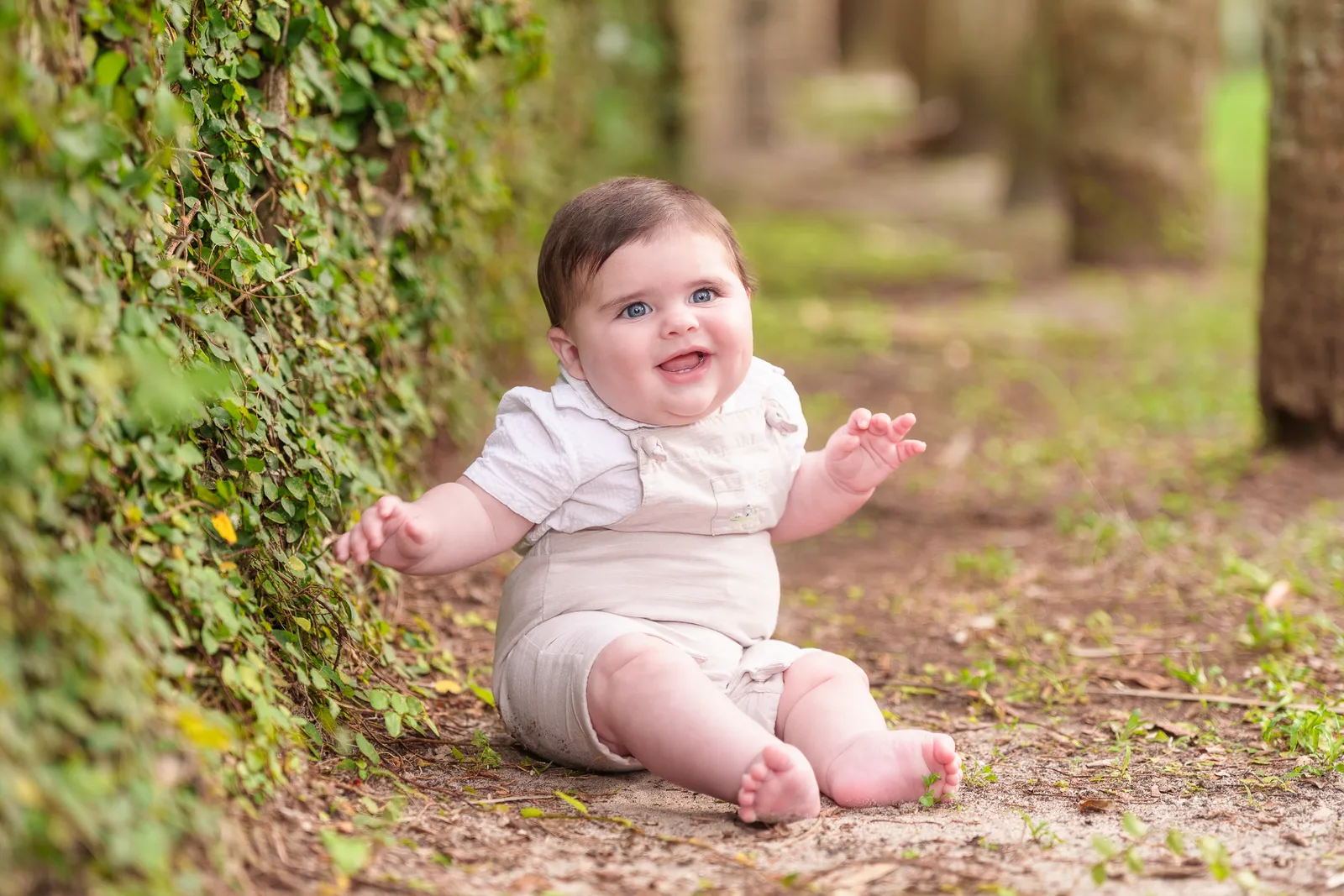 Baby boy sitting by the ivy wall - Huntington Beach State Park