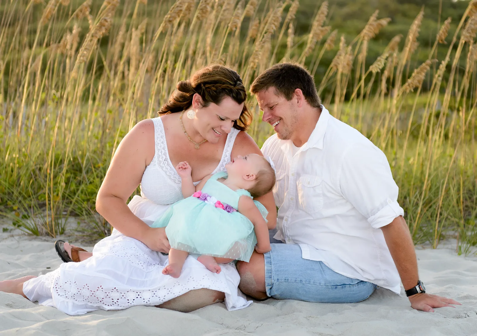 Family looking down at baby girl - Myrtle Beach State Park
