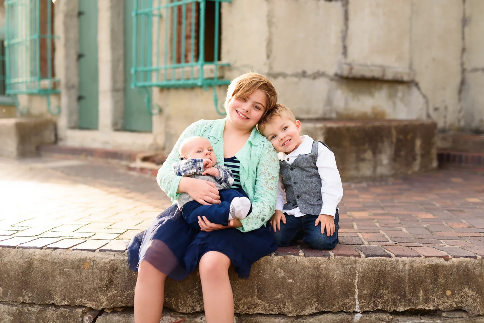 Sister with her two little brothers sitting behind Atalaya Castle - Murrells Inlet