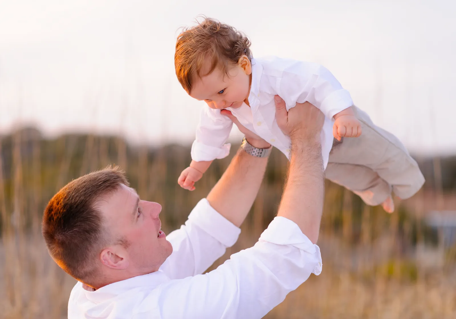 Little boy getting held in the air by dad - Myrtle Beach State Park