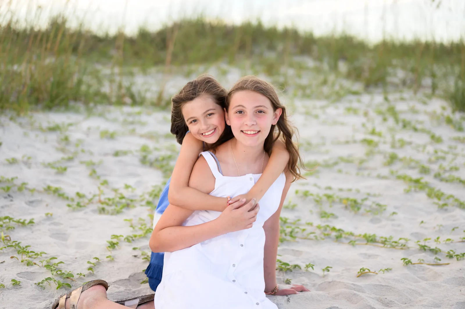 Little sister giving big sister a hug - Huntington Beach State Park