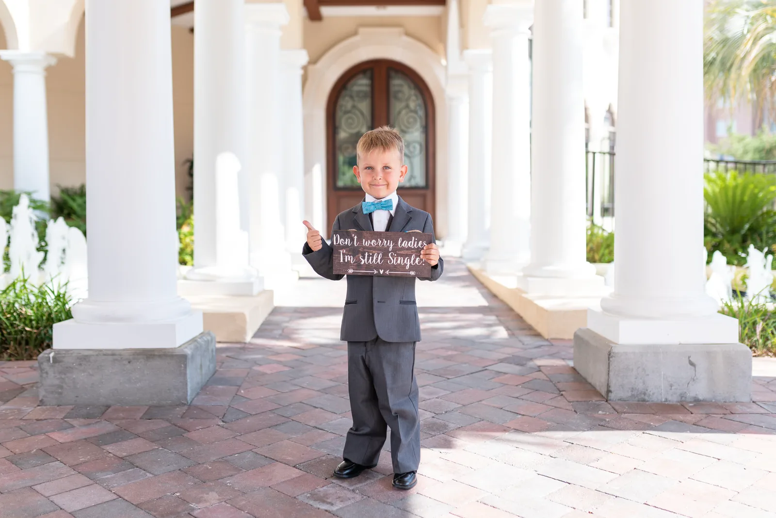 Little boy holding up I'm still single sign - Grande Dunes Ocean Club