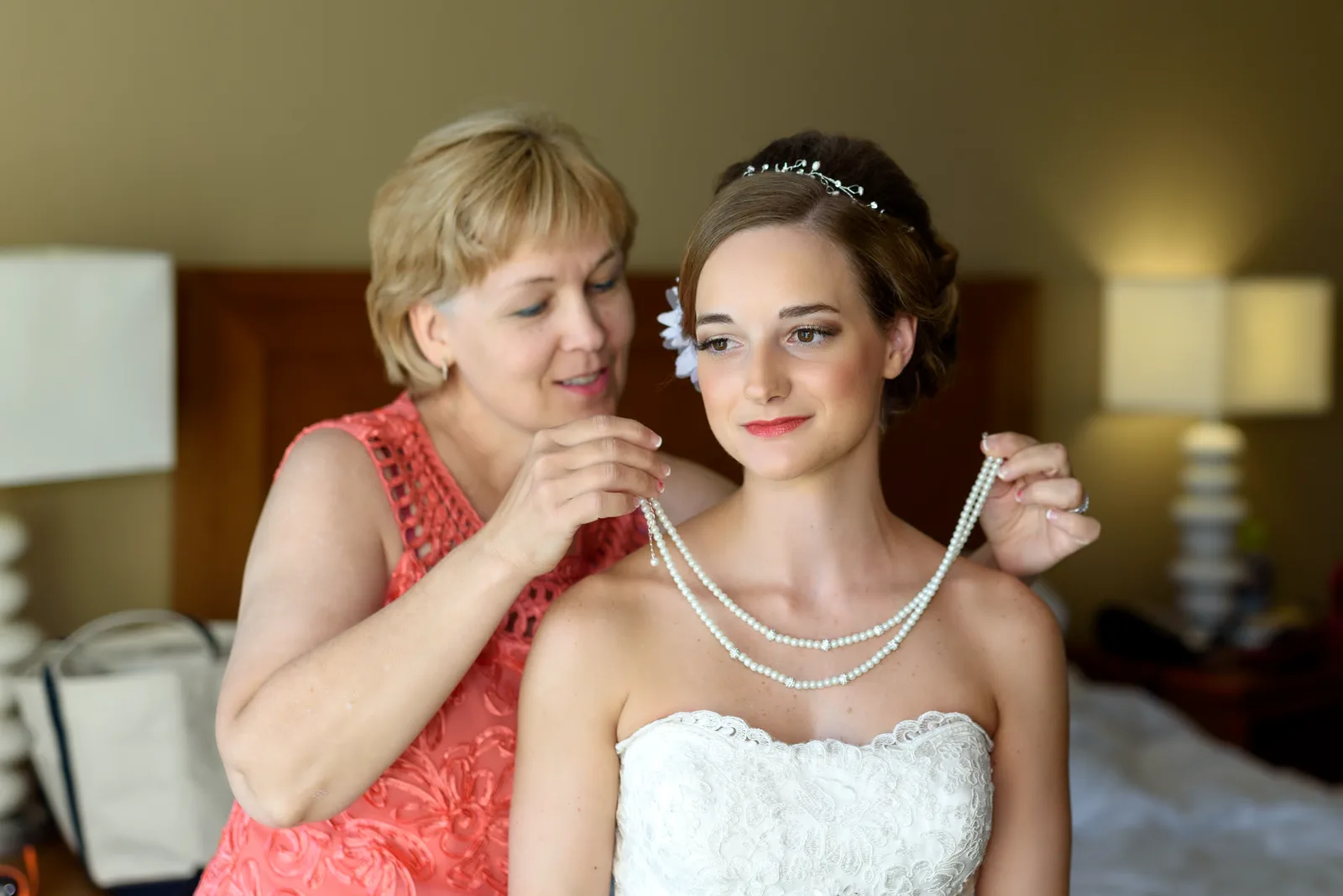 Bride's mom putting on her necklace before the ceremony  - Hilton at Kingston Plantation