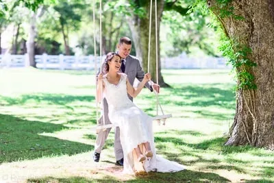 Groom pushing bride on a swing - Wildberry Farm