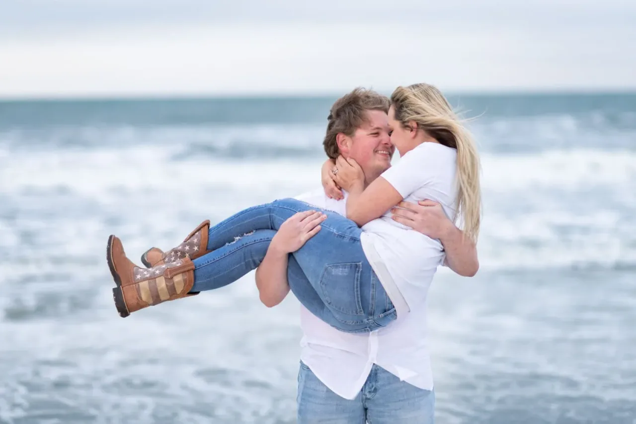 Lifting into his arms with cowboy boots - Huntington Beach State Park