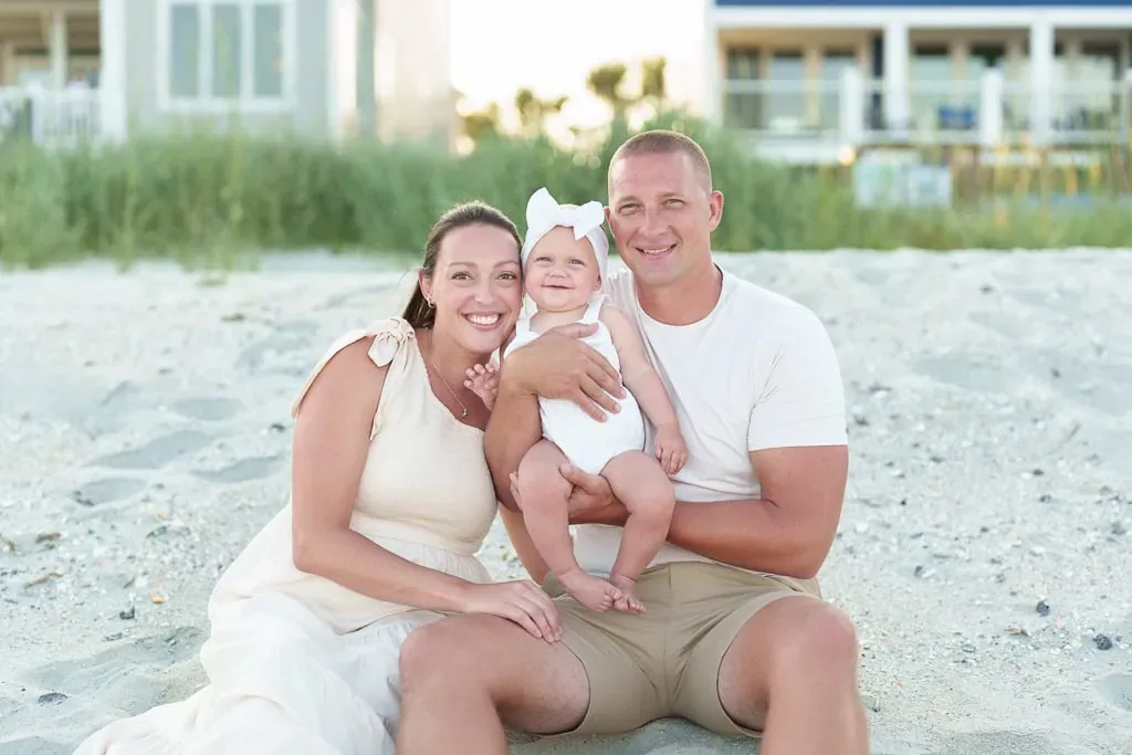 Mother and father with baby girl on the beach