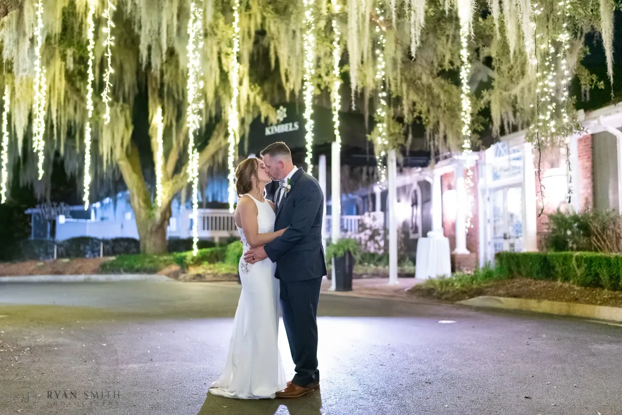 Portrait under the lights hanging from the trees at the Kimbels - Kimbels at Wachesaw Plantation