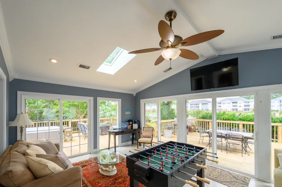 Recreation room with a foosball table and sliding doors onto the deck in a Myrtle Beach home