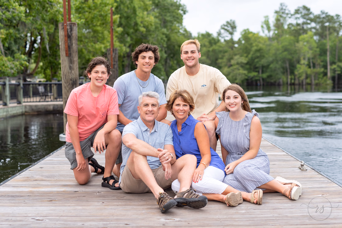 Family of 6 sitting by the river - Conway Riverwalk