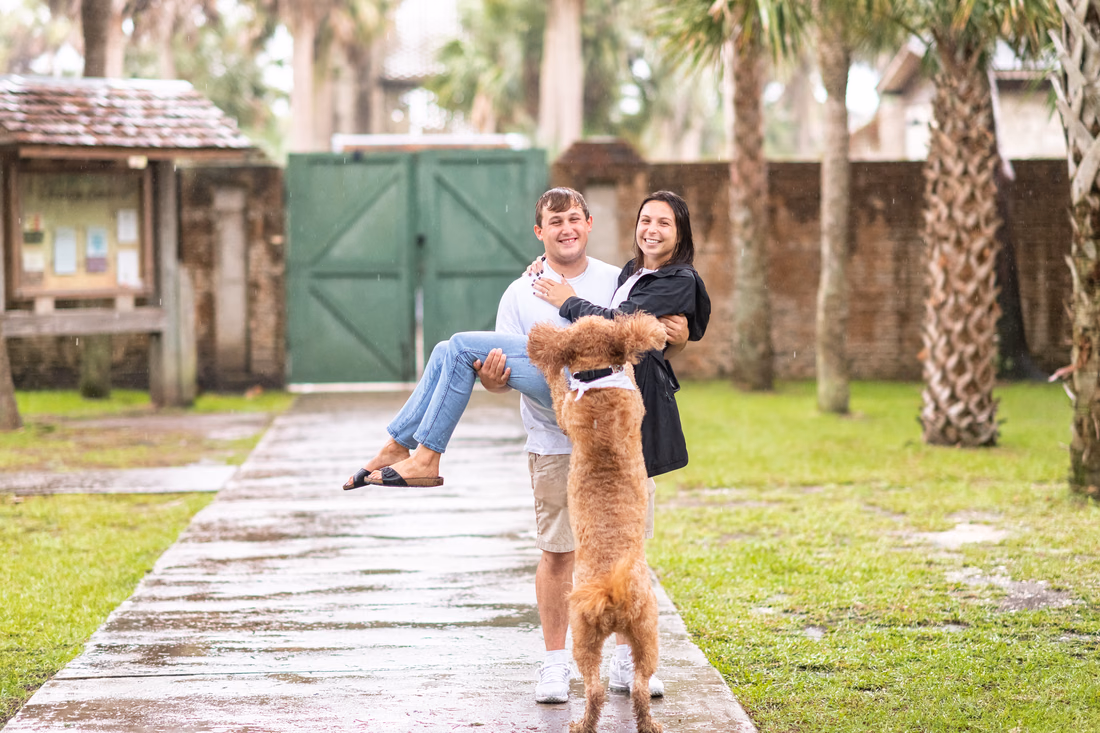 Engagement pictures in the pouring rain with their dog - Huntington Beach State Park