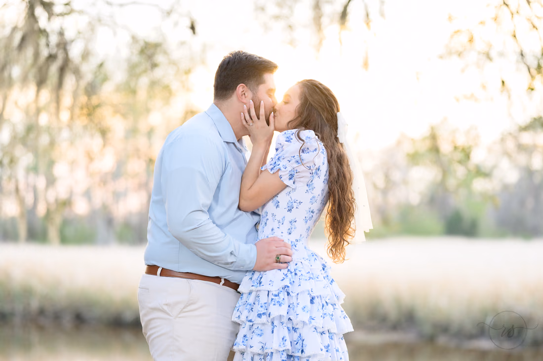 Close kiss backlit by the setting sun by the river at Caledonia Golf and Fish Club
