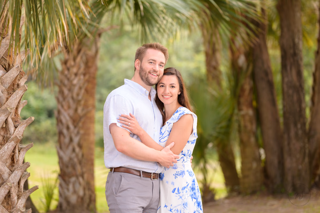Big smiles in front of the palm trees - Huntington Beach State Park