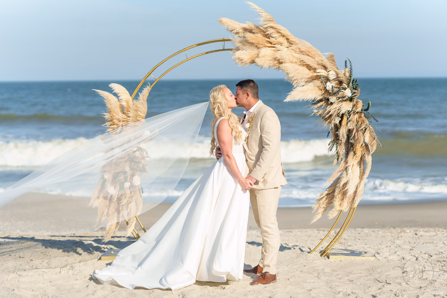 Veil blowing in the wind under the wedding arch in strong direct sun - Beach House in Pawleys Island